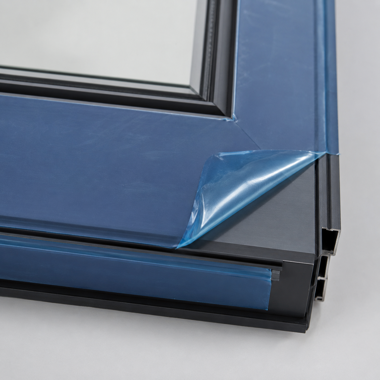 Removable protective film being peeled from a coated metal door frame